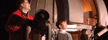 Presenters showing visitors telescope
